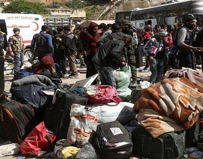 Families leaving Eastern Ghouta take prize possessions